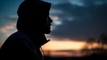 Side view, Silhouette of the face, a person, low angle, blurred fresh dawn sky. photo