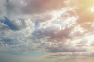 Blue sky background with white fluffy clouds in daytime outdoors photo