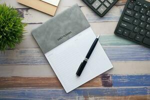 weekly planner and notepad on table photo