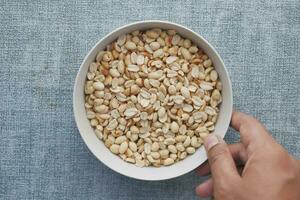 peeled peanuts in a bowl on table photo