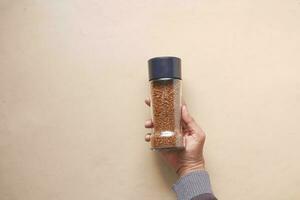 men holding a coffee powder jar on table photo