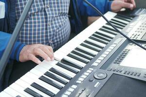 men's hands playing grand piano photo