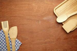 wooden cutlery forks on light yellow background photo