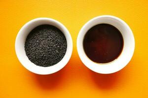 Black Cumin seed and oil in a container photo