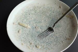 Empty plate after eating on table photo