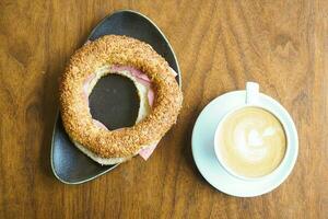 top view of late coffee and simit bread on table . photo