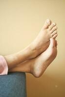 relax women feet lying on sofa in a bright house photo