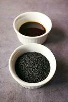 Black Cumin seed in a container on table photo