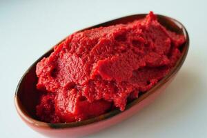 Tomato paste with ripe tomatoes. photo