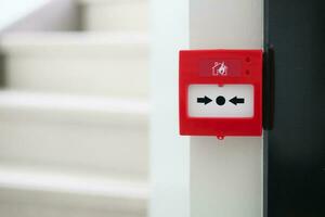 Red fire alarm button on wall , photo