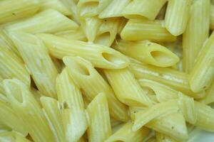 homemade cooked pasta in a plate on table . photo