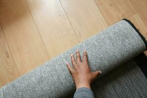 Seamless grey carpet texture background on wooden floor with copy space photo