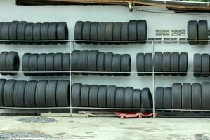 used old car tires on shelves at auto store photo