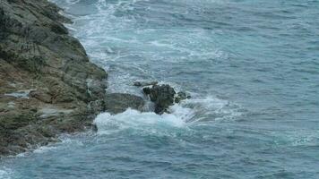 Waves breaking near a rocky shore video