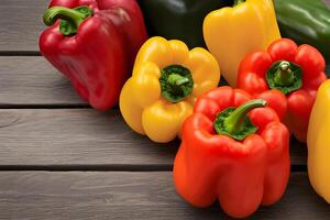 Bunch of different bell peppers on wooden table free image photo