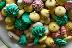 Mixed coloured meringues in a buffet photo