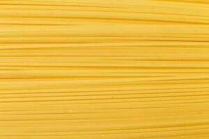 spaghetti yellow background close. raw pasta macro photo