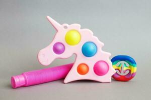 colorful antistress sensory fidget toys on a gray background. photo