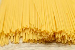 spaghetti yellow background close. raw pasta macro photo