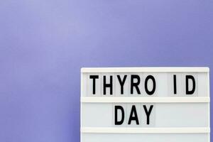inscription international thyroid day on purple background. copy space photo