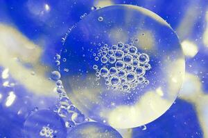 Oil bubbles close up. circles of water macro. abstract light blue background photo