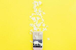 white hydrangea flowers and paint brush on a yellow background with copy space. photo