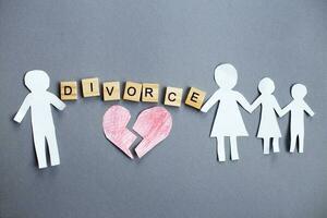 Paper chain cut family with broken heart on gray background. Divorce and broken family concept photo
