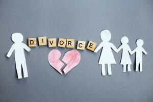 Paper chain cut family with broken heart on gray background. Divorce and broken family concept photo