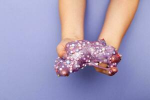 Making slime at home. child stretching colorful slime. DIY concept. photo