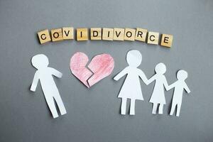 Paper chain cut family with broken heart on gray background. divorce in the covid pandemic photo