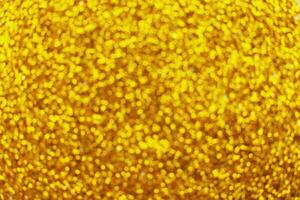 glittering background of golden sequins closeup. Sparkle festive texture photo