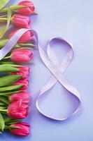 8 March card design with pink tulips and ribbon in the shape of number eight. International Women s Day photo