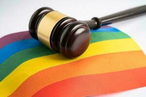 Gavel for judge lawyer on rainbow flag, symbol of LGBT pride month celebrate annual in June social of gay, lesbian, bisexual, transgender, human rights. photo