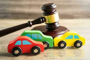 Hammer gavel judge with car vehicle accident, insurance coverage claim lawsuit court case. photo