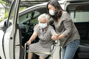 Asian senior woman patient sitting on walker prepare get to her car, healthy strong medical concept. photo