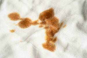 Dirty sauce stain on cloth to wash with washing powder, cleaning housework concept. photo