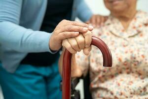 Caregiver help Asian elderly woman patient with love, care, encourage and empathy at nursing hospital, healthy strong medical concept. photo