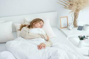 Woman sleeping at bed at home photo