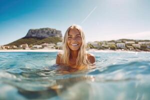 Young woman in her 30 years old swimming on supboard on the beach. photo