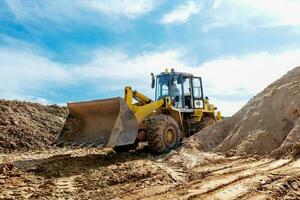 Wheel machine for loading performs work on laying large diameter pipes photo