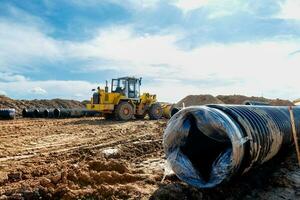 Wheel machine for loading performs work on laying large diameter pipes photo