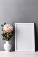 Empty white frame mockup with Scandinavian look, protea flowers in vase, photo