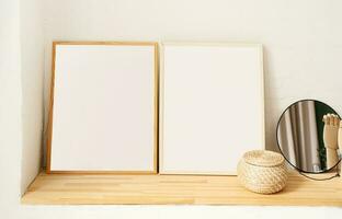 set of empty wooden photo frames for mockup design on the wooden shelf