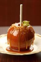 Delicious caramel apple wooden stick on plate. photo
