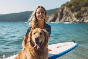 Young woman and her dog using supboard on the beach. photo