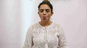 Video of woman performing Sheetali Pranayama