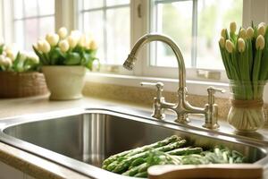 Fresh asparagus in kitchen sink, photo