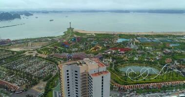 4k Aerial view over city and park with Bai Tho karst mountain Ha long bay. Halong City, Vietnam video