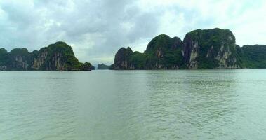 4k Aerial Over boats docked in bay with karst mountains. Ha long bay. Halong City, Vietnam video