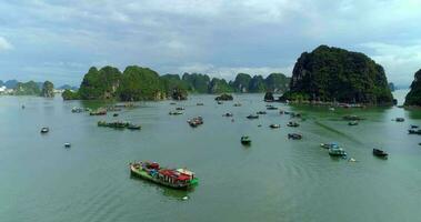 4k Aerial Over boats docked in bay with karst mountains. Ha long bay. Halong City, Vietnam video